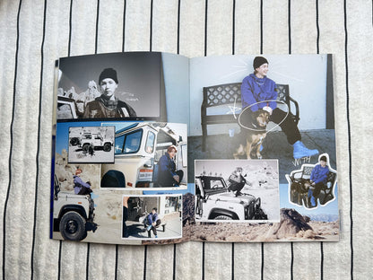 Open photo album with images of people and vehicles on a wooden surface