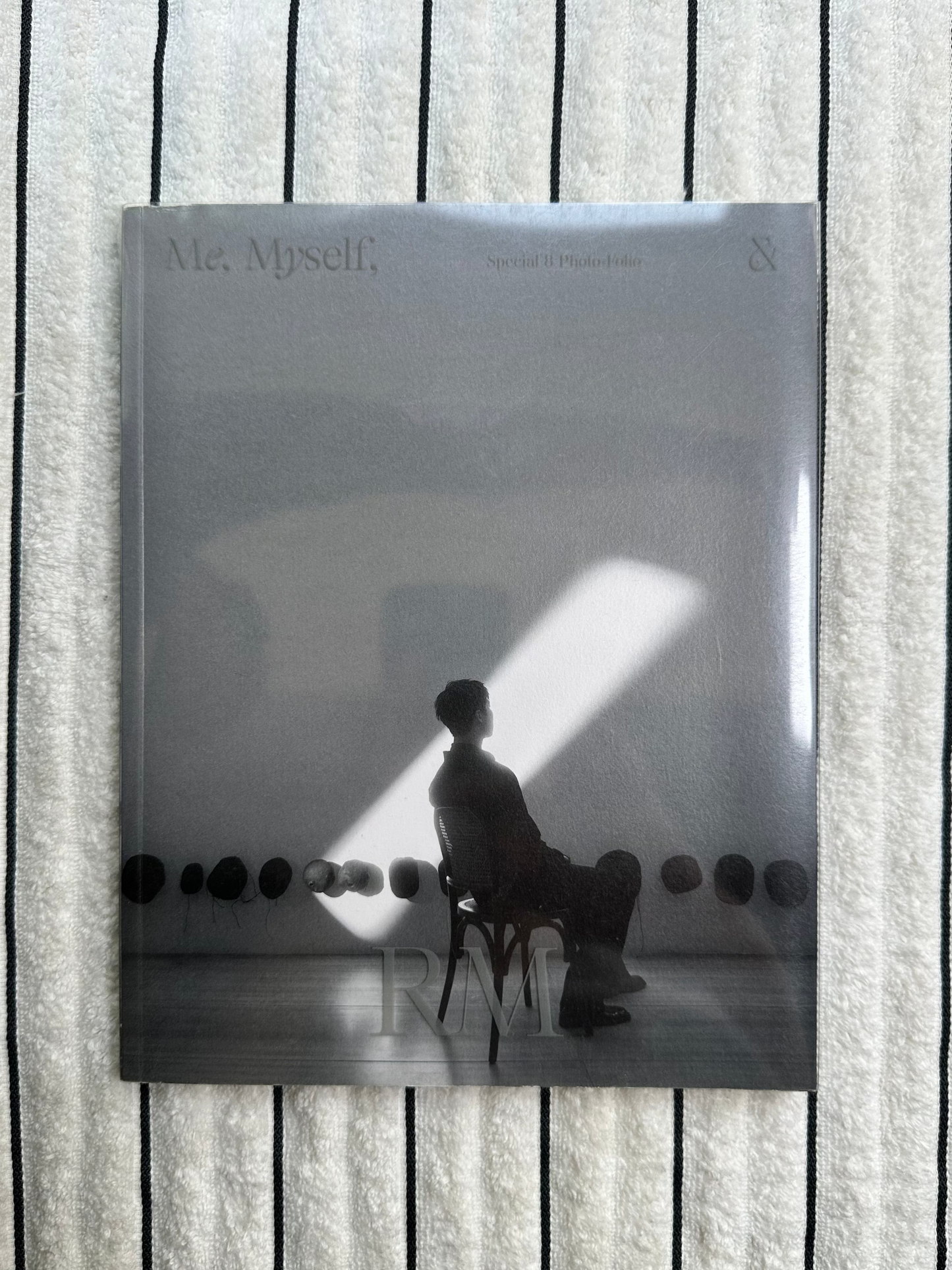 Album cover with a person's silhouette on a striped background