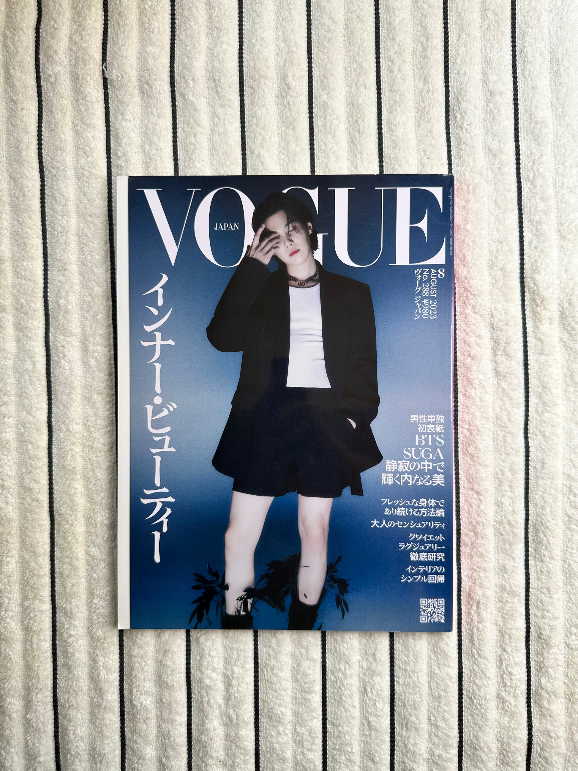 Magazine cover with two people on a striped fabric background