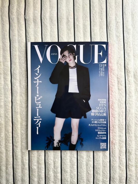 Magazine cover with two people on a striped fabric background