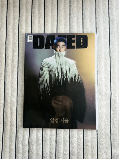 Magazine cover with a RM wearing a textured sweater on a striped background