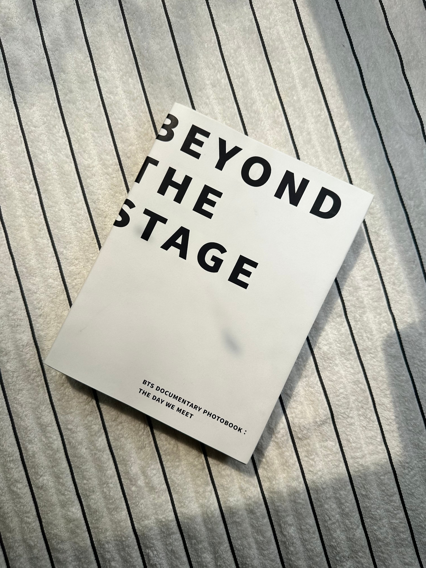 Book titled 'Beyond the Stage' on a wooden surface