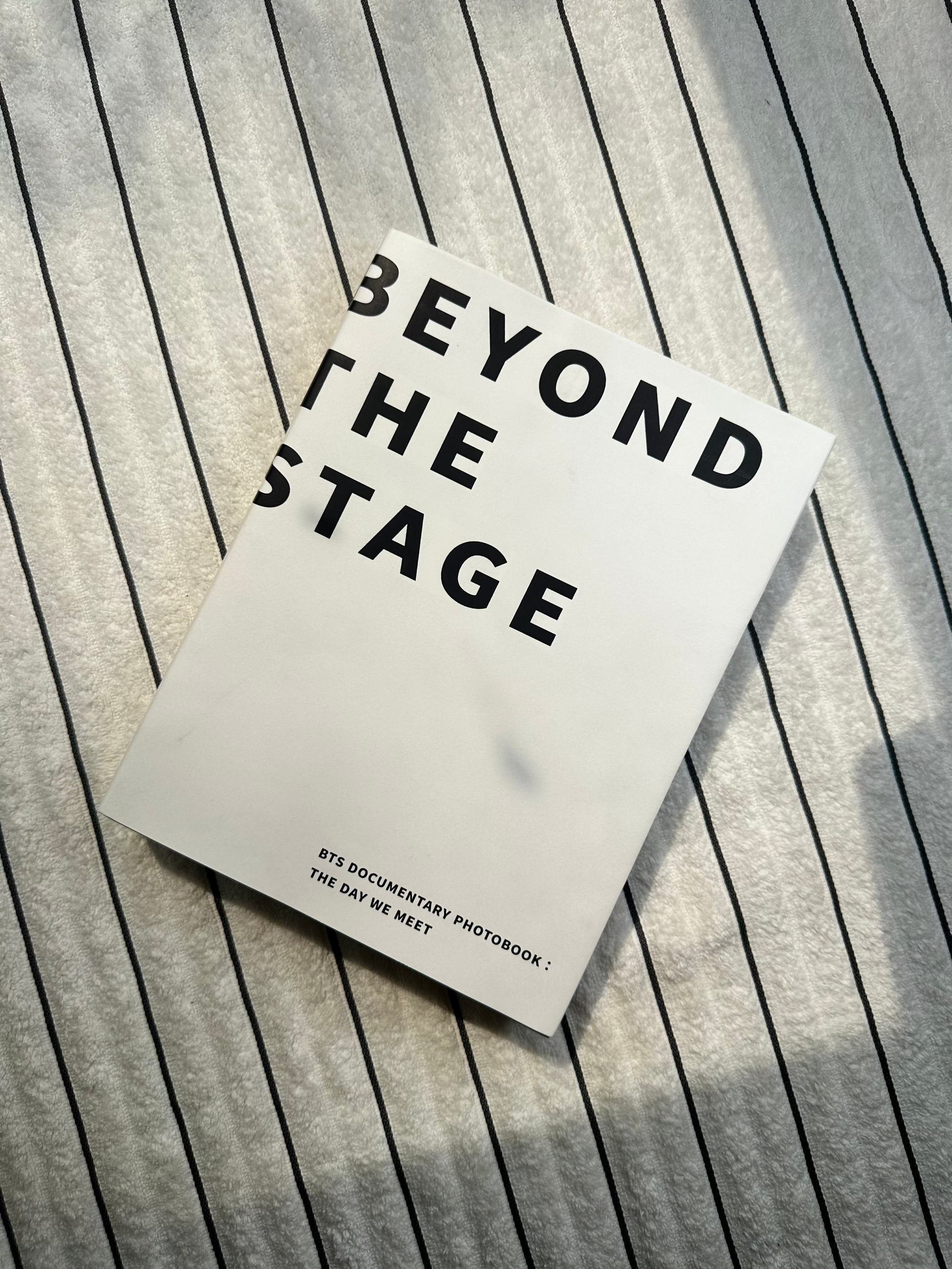 Book titled 'Beyond the Stage' on a wooden surface