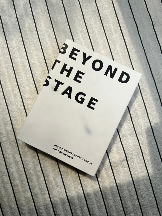Book titled 'Beyond the Stage' on a wooden surface